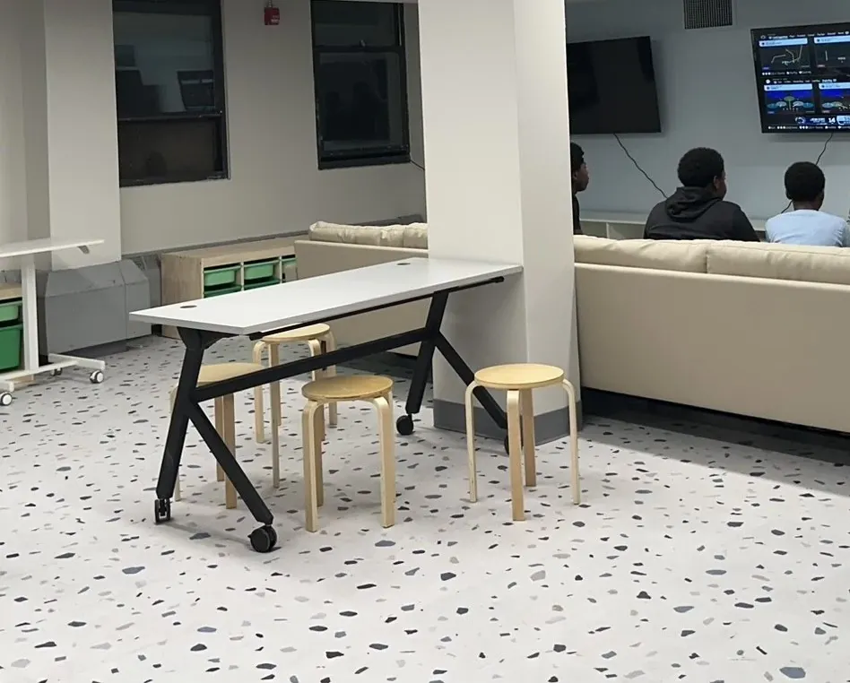 Modern lounge area with terrazzo flooring and seating