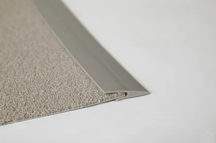 Durable beige carpet tile for commercial spaces Close-up of beige commercial carpet tile with edge trim