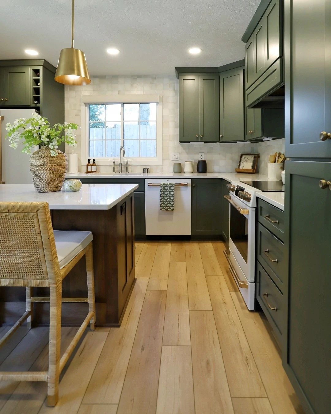 kitchen with green cabinets and luxury vinyl plank floor in a wood look