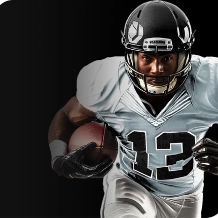 Football Player in Action Football player in black helmet and white jersey holding a football