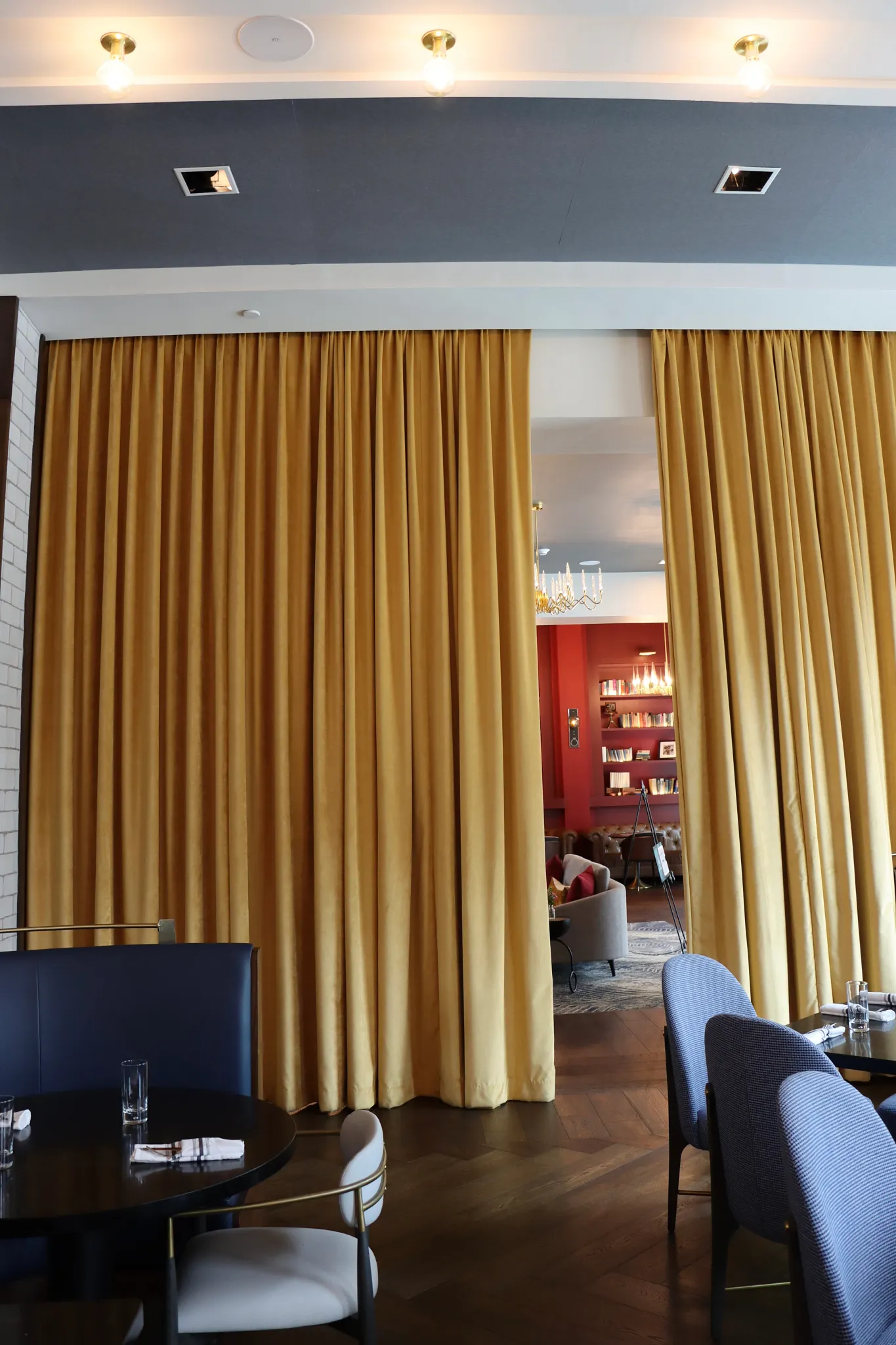 Elegant restaurant interior with wooden flooring and gold curtains
