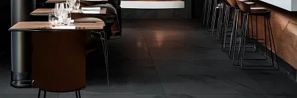 Stylish porcelain tile flooring for hospitality spaces Modern restaurant interior with dark porcelain tile flooring