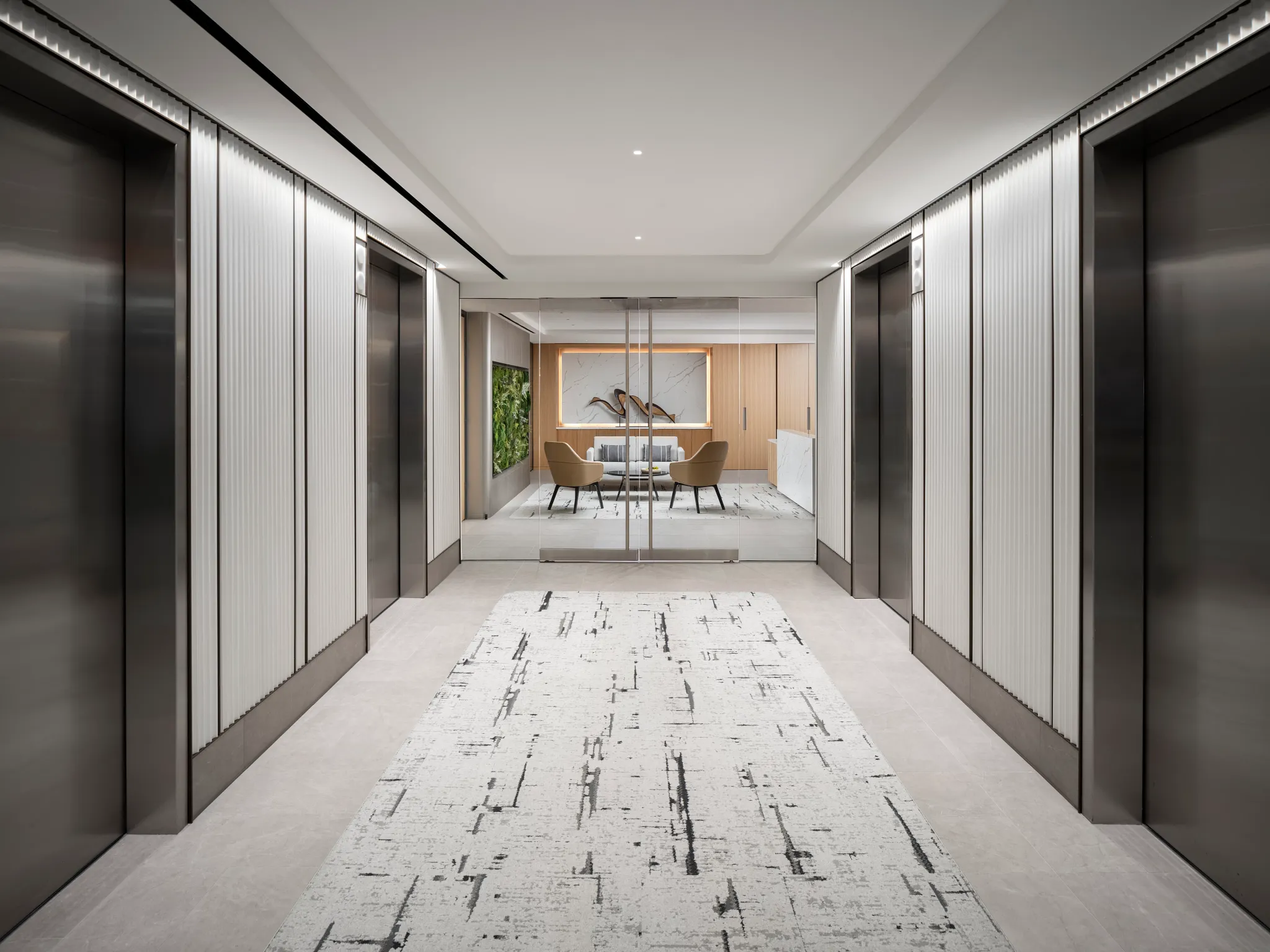 Modern office hallway with abstract patterned carpet and sleek elevator doors