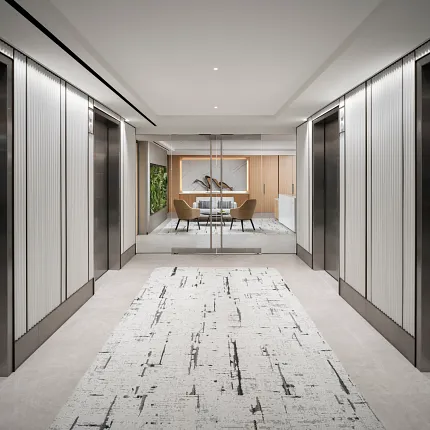 Modern office hallway with abstract patterned carpet and sleek elevator doors