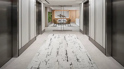 Contemporary Workplace Hallway with Stylish Carpet Design Modern office hallway with abstract patterned carpet and sleek elevator doors