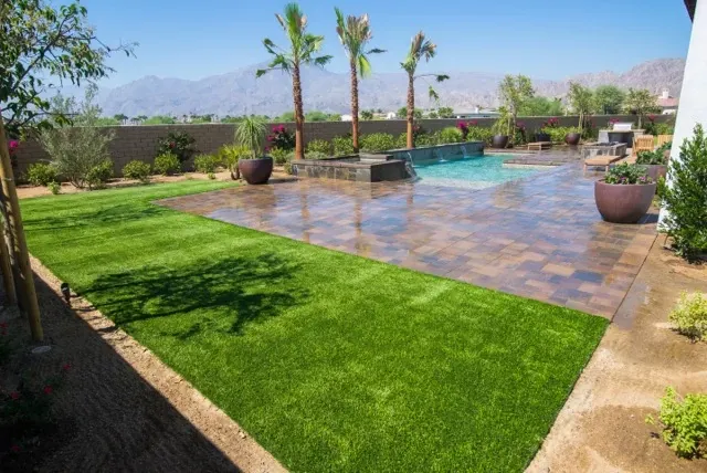 Outdoor patio with artificial grass and pool