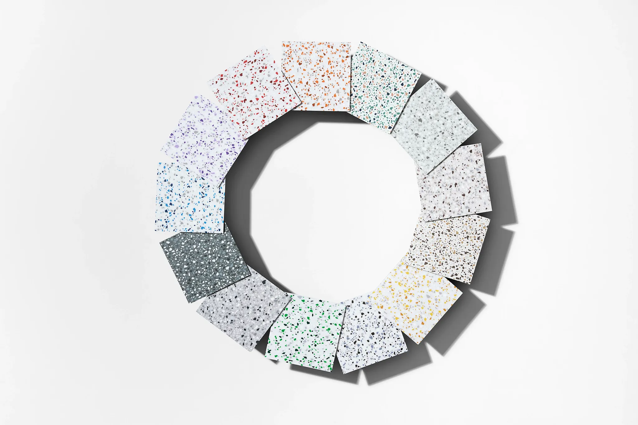Terrazzo flooring samples in various colors including red, orange, green, blue, and gray