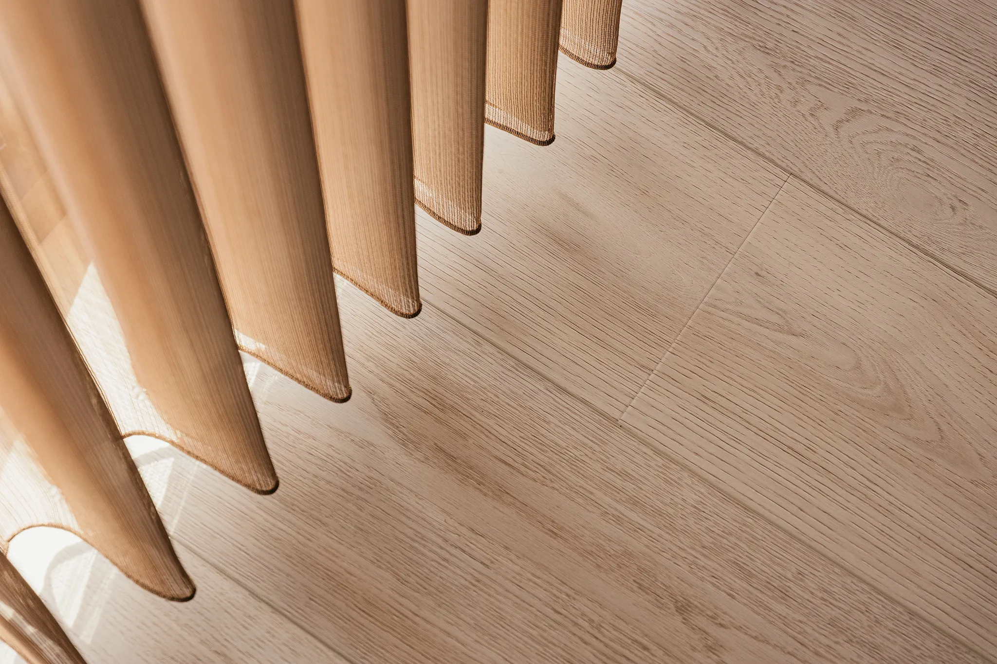 Light wood look vinyl flooring with sheer curtains