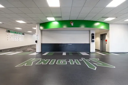 Durable LVT flooring for educational spaces Education facility with heavy commercial luxury vinyl tile flooring featuring "Knights" logo