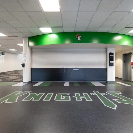 Durable LVT flooring in educational spaces Education facility with heavy commercial luxury vinyl tile flooring featuring "Knights" logo