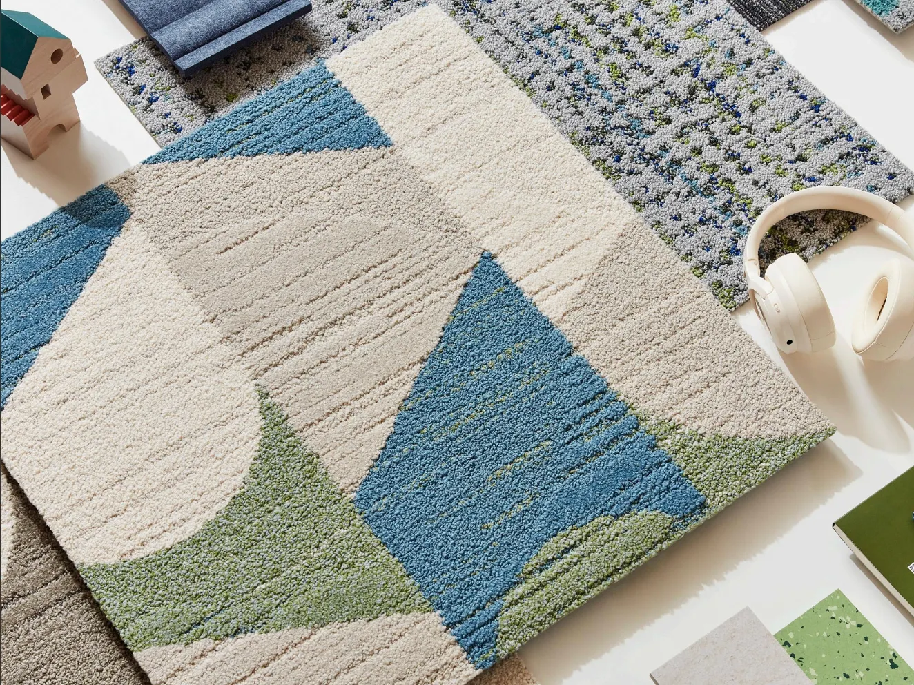 Carpet swatch in blue, green, and beige geometric pattern