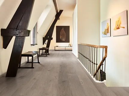 Light Gray Wood Look Luxury Vinyl Plank Flooring in Modern Hallway Modern hallway with wood look luxury vinyl plank flooring featuring light gray tones and rustic beams