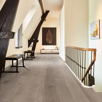 Light Gray Wood Look Luxury Vinyl Plank Flooring in Modern Hallway Modern hallway with wood look luxury vinyl plank flooring featuring light gray tones and rustic beams