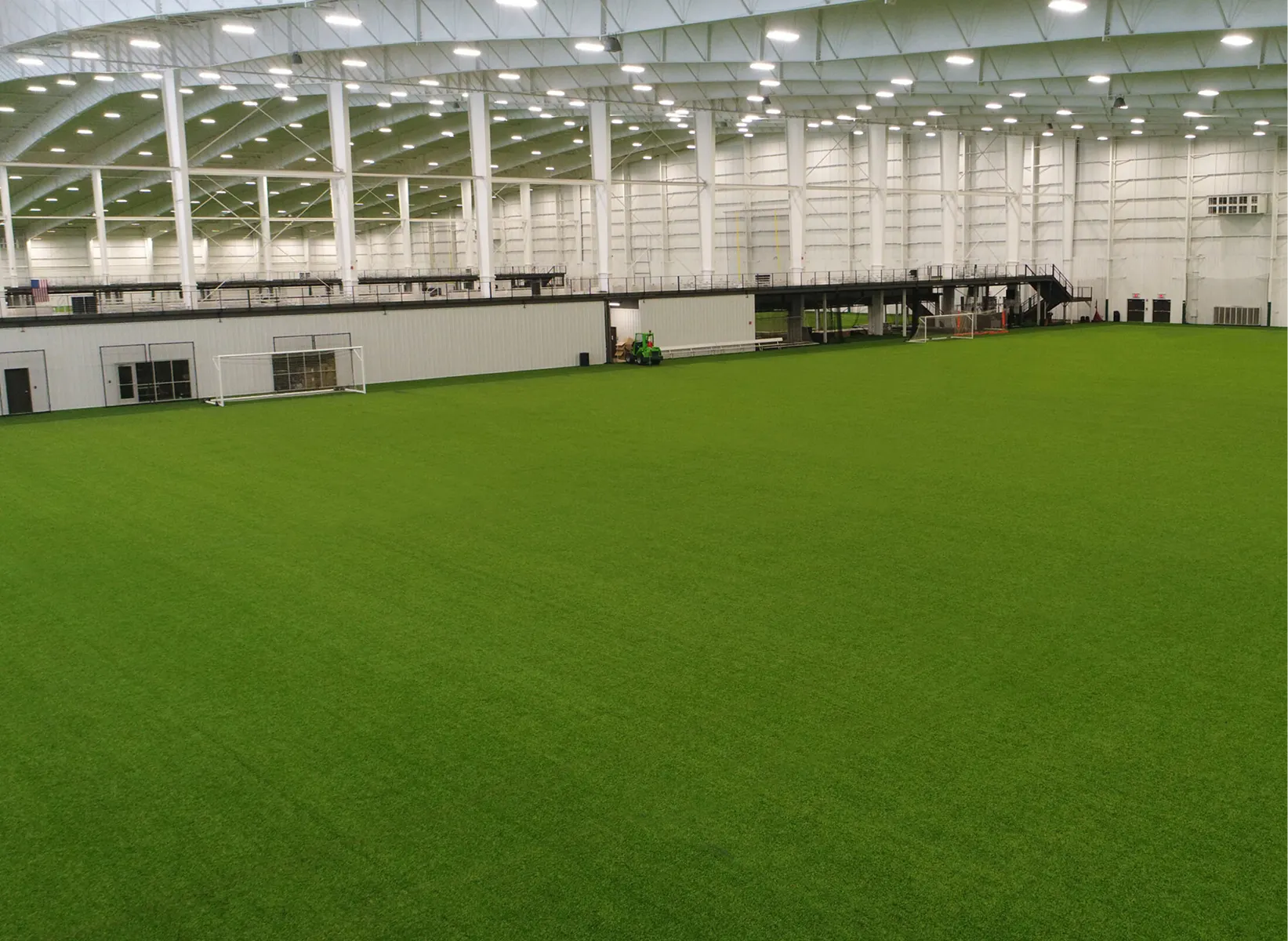 Indoor sports facility with green artificial turf