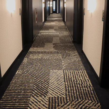 Stylish commercial carpet for hospitality settings Patterned carpet in a hotel hallway