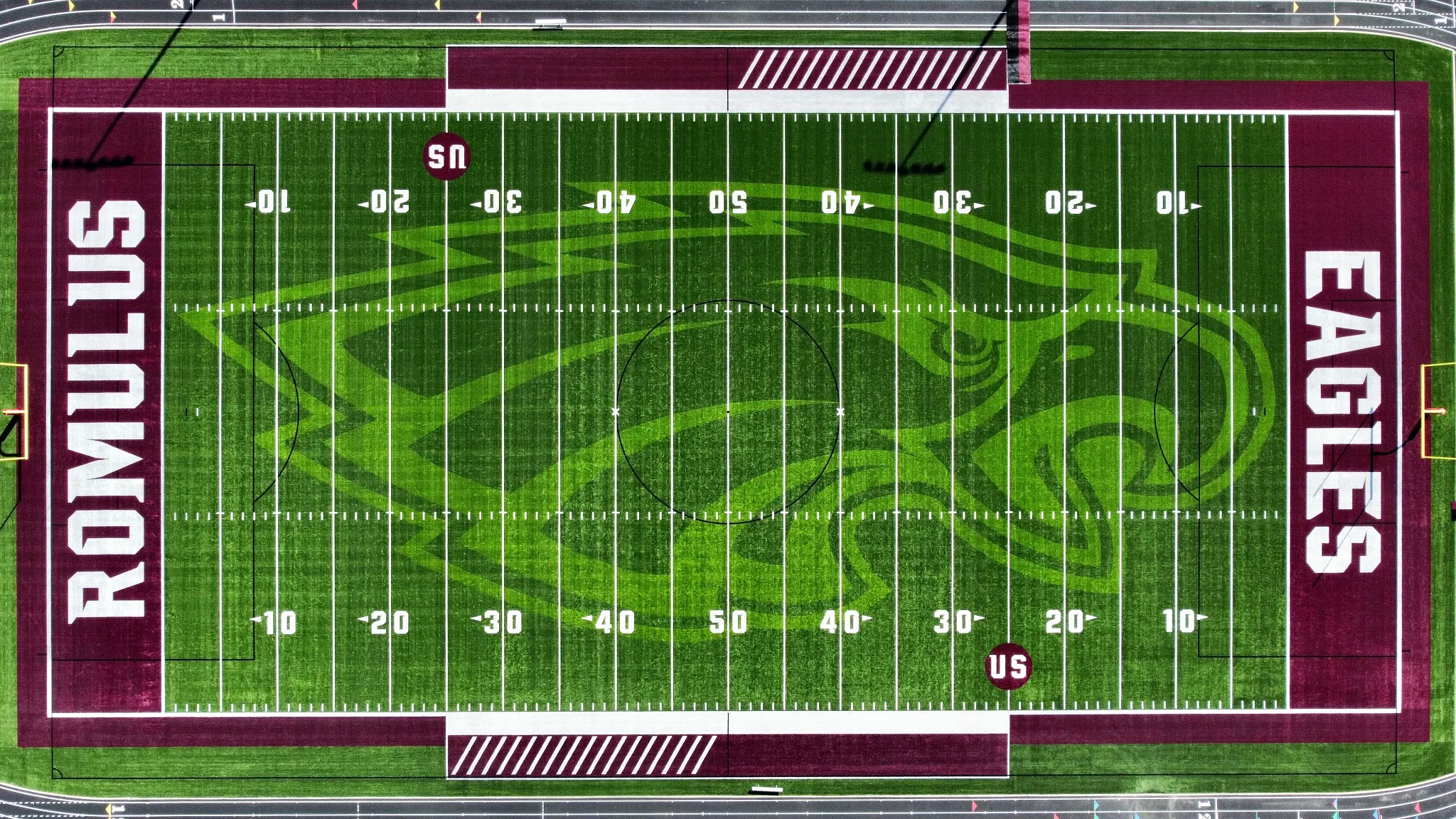 Aerial view of Romulus Eagles football field with artificial turf featuring green and maroon colors