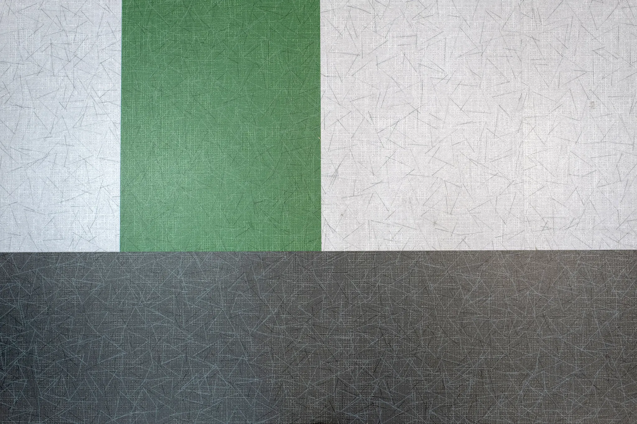 Swatch of heavy commercial luxury vinyl tile in green, light gray, and dark gray colors