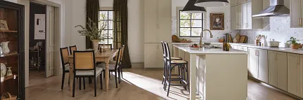 Light Hardwood Flooring in a Contemporary Kitchen and Dining Space Modern kitchen and dining area with light hardwood flooring, featuring a cozy and practical design with natural light