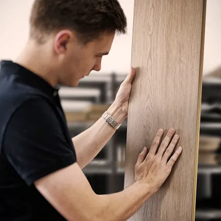 Wood Look Luxury Vinyl Plank Flooring Inspection in Workshop Man examining wood look luxury vinyl plank flooring in a workshop setting