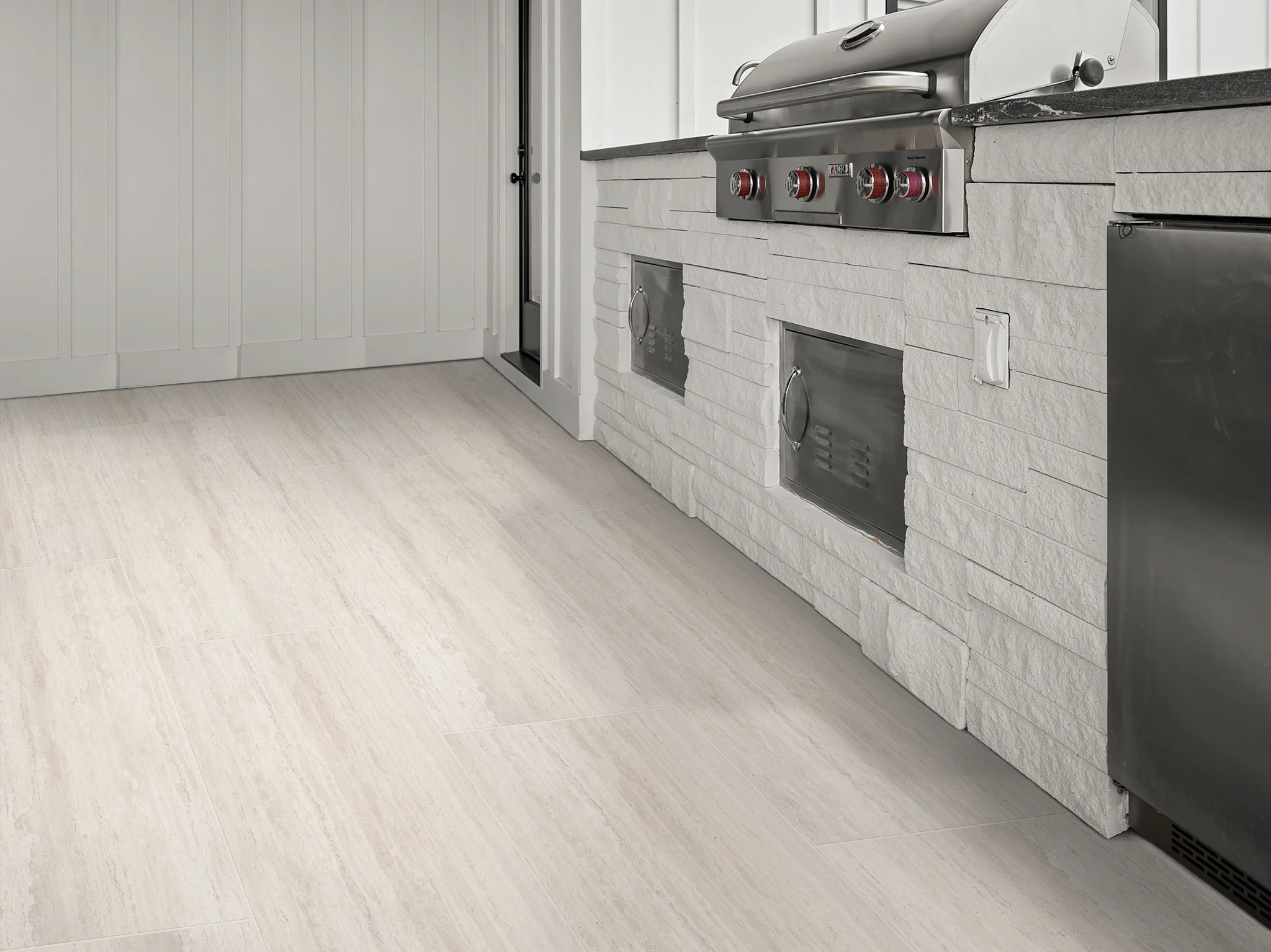 Modern outdoor kitchen with durable light beige tile flooring