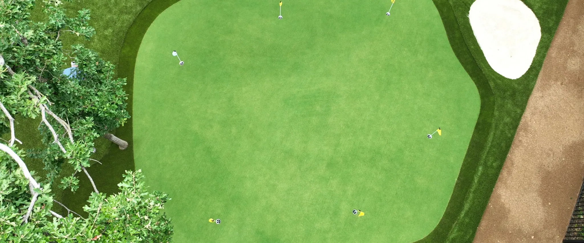 Aerial view of a golf course with green grass and sand trap
