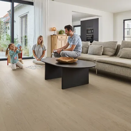 Light Wood Look Luxury Vinyl Plank Flooring in Modern Living Room Scene Modern living room with light wood look luxury vinyl plank flooring, featuring a family enjoying quality time together