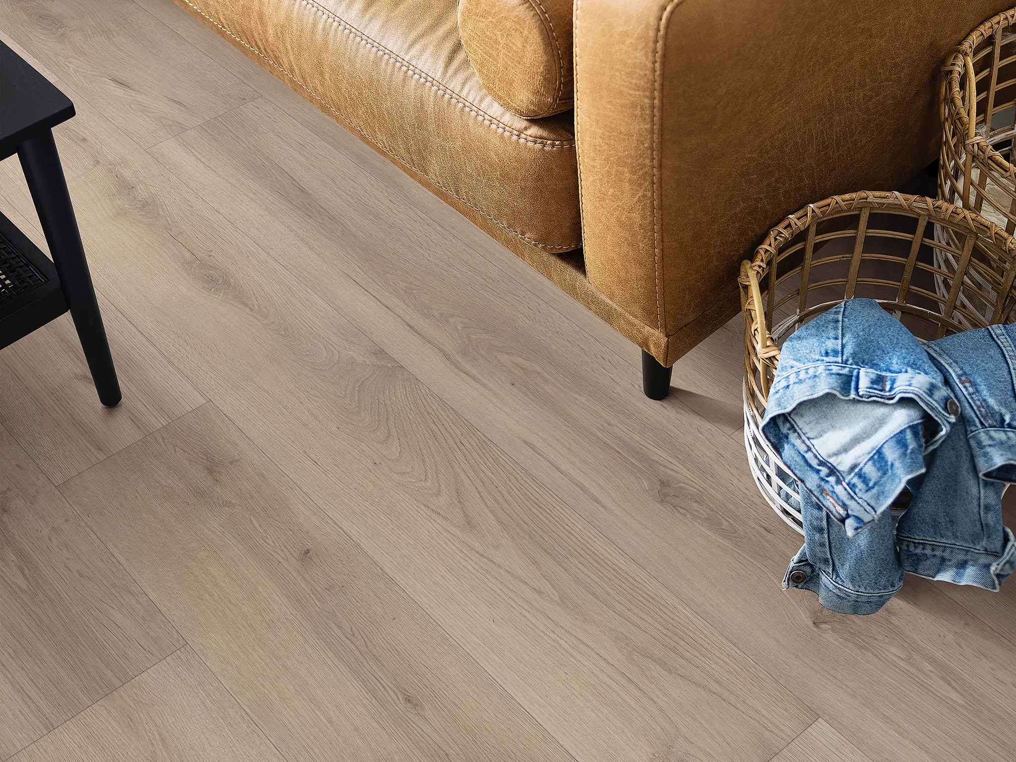 WPC flooring in a cozy living room with a leather sofa and denim