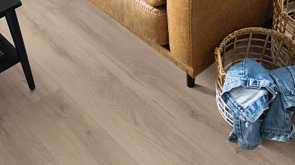 Durable WPC flooring for everyday comfort WPC flooring in a cozy living room with a leather sofa and denim