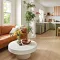 <h2 class="text-bodycopy-l"><span style="color:#ffffff;"><strong>Need Design Help?</strong></span></h2>
Cozy living room with light wood laminate flooring, brown leather sofa, and modern kitchen