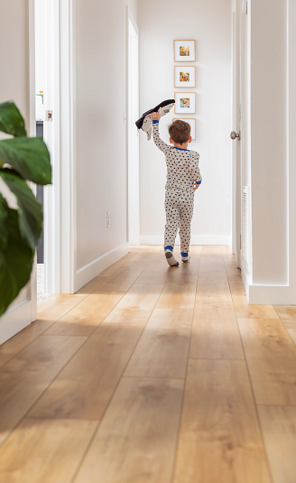 child walking down a hallway featuring coretec vinyl flooring