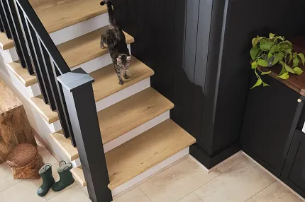Wood Look Vinyl Flooring on Stairs with Stone Look Vinyl Tiles - Coretec Residential SPC Cat walking down stairs with wood look vinyl flooring and beige stone look vinyl tiles, 24.02x12.01 inch, Coretec Residential SPC