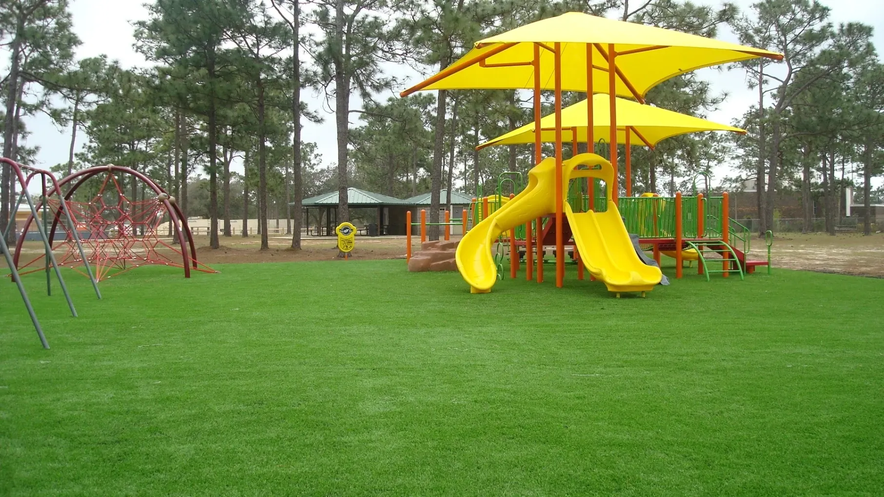 Playground with artificial grass and yellow slide