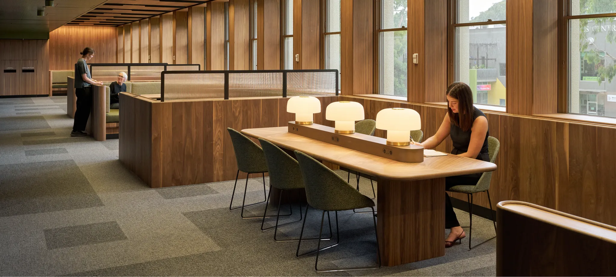 Study and collaboration area within the Monash University Clayton Menzies Building Level 1 Teaching Space Upgrades project by Hayball, featuring timber finishes, integrated booth seating and flexible learning spaces.