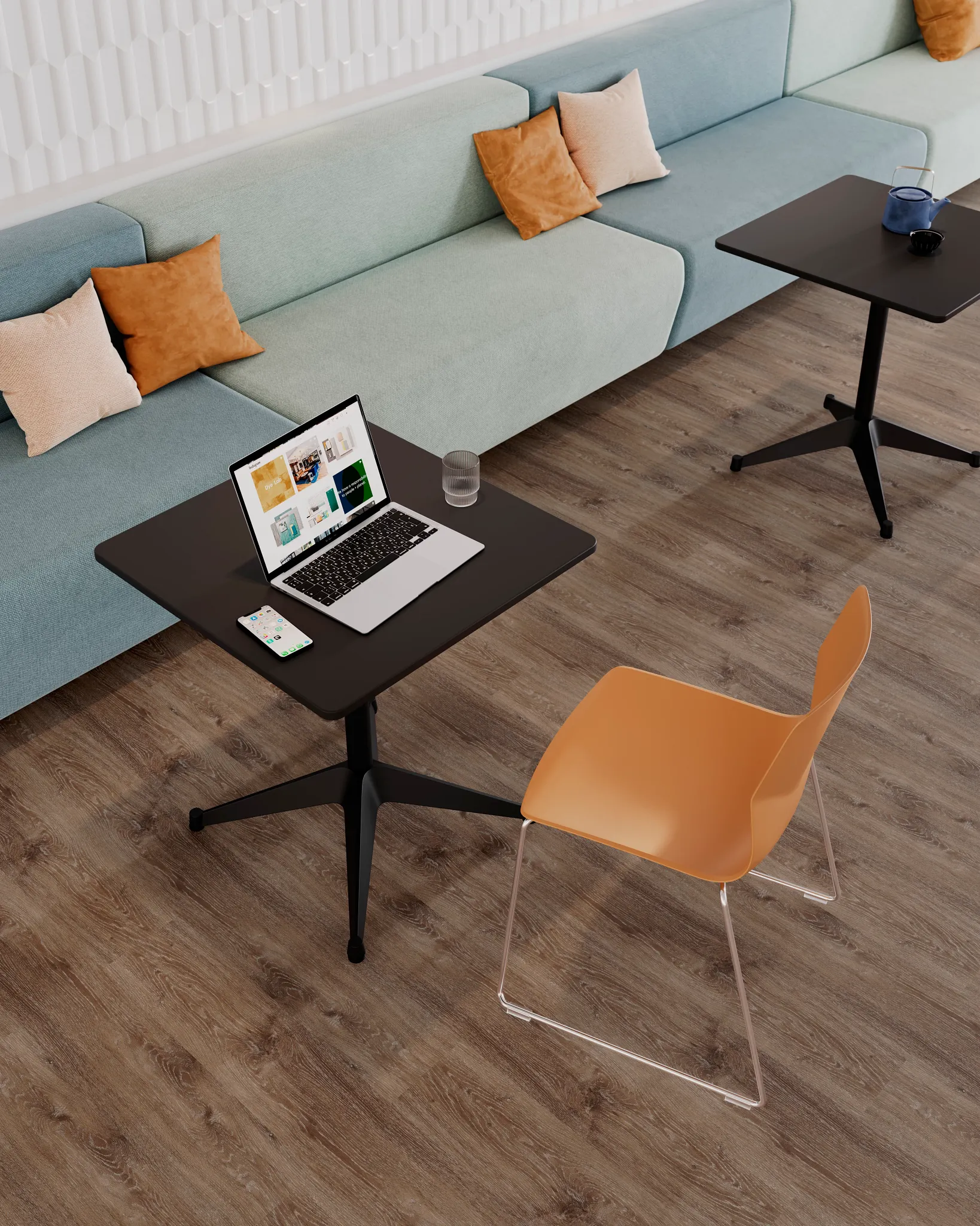 Modern workspace with light brown wood-look flooring, black tables, orange chair, and pastel blue sofa with pillows