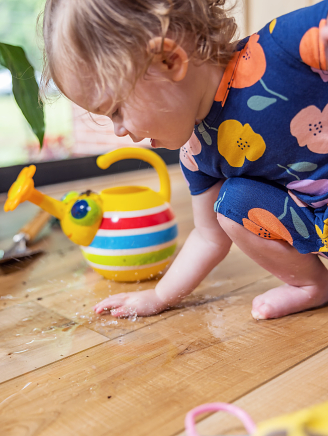 A baby playing with water toys on a COREtec vinyl floor