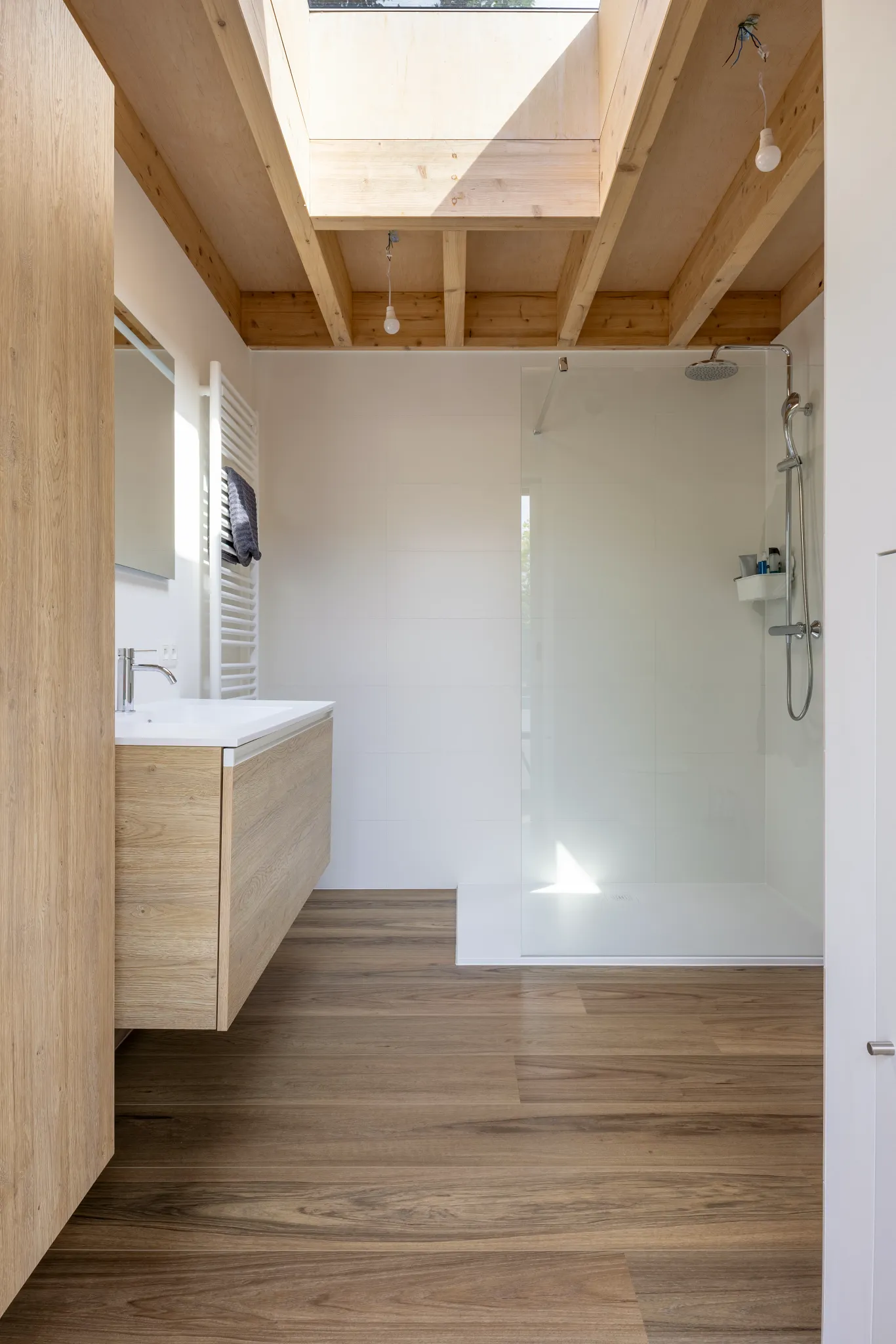 Wood oak look luxury vinyl plank floor shade dark brown in industrial bathroom
