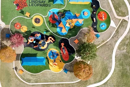 Vibrant playground design with school branding Aerial view of colorful playground with Lindsay Leopards logo