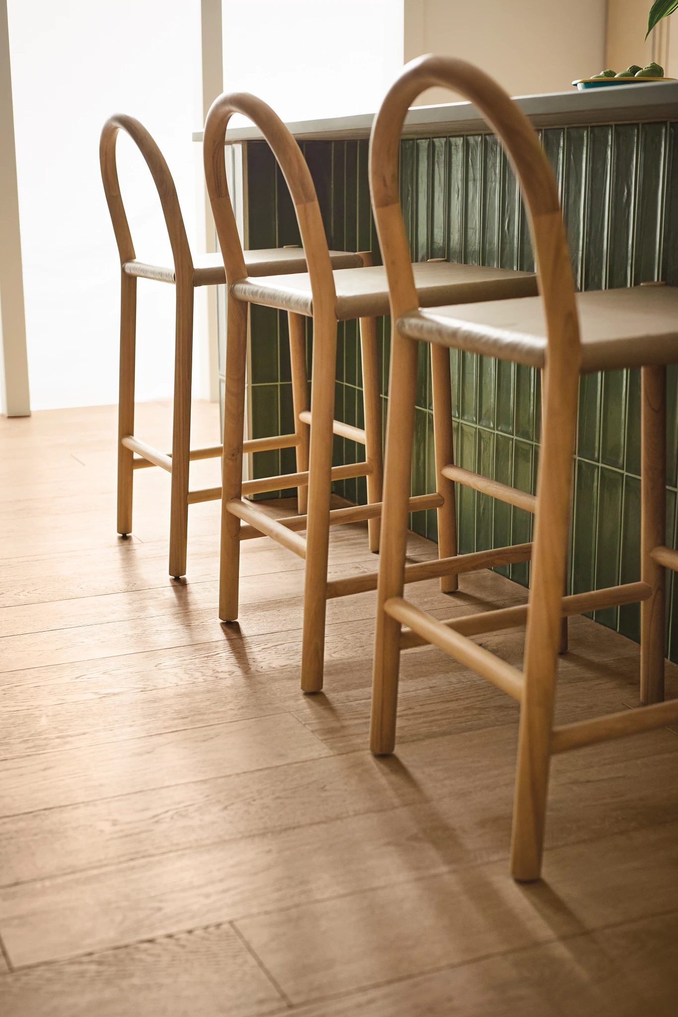 Modern dining room with light brown hardwood flooring and wooden chairs