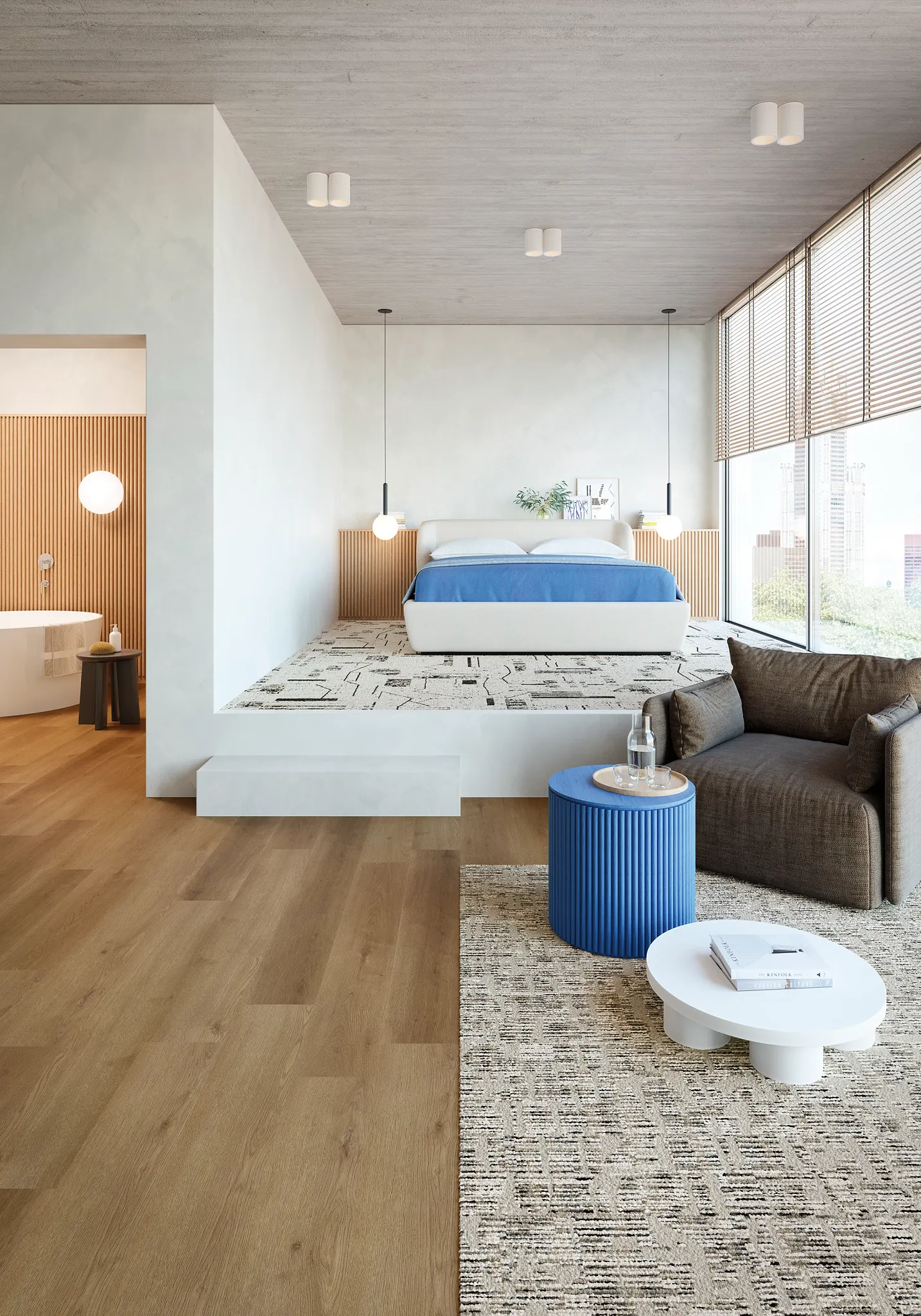 Modern bedroom with light wood flooring and patterned carpet, featuring a blue bed and contemporary furniture