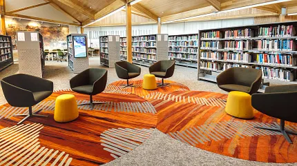 University of Tasmania Library Featuring Custom Carpet Flooring Design | Shaw Contract Custom carpet flooring installation within the University of Tasmania library, featuring organic patterns inspired by Indigenous storytelling and collaborative seating areas.