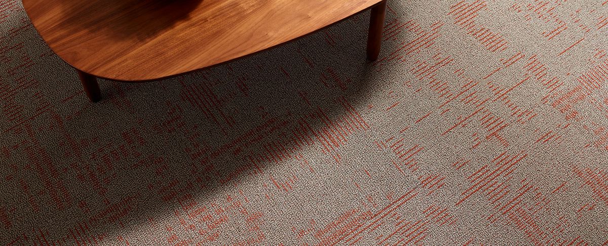 Closeup of a living room coffee table and carpet tile flooring