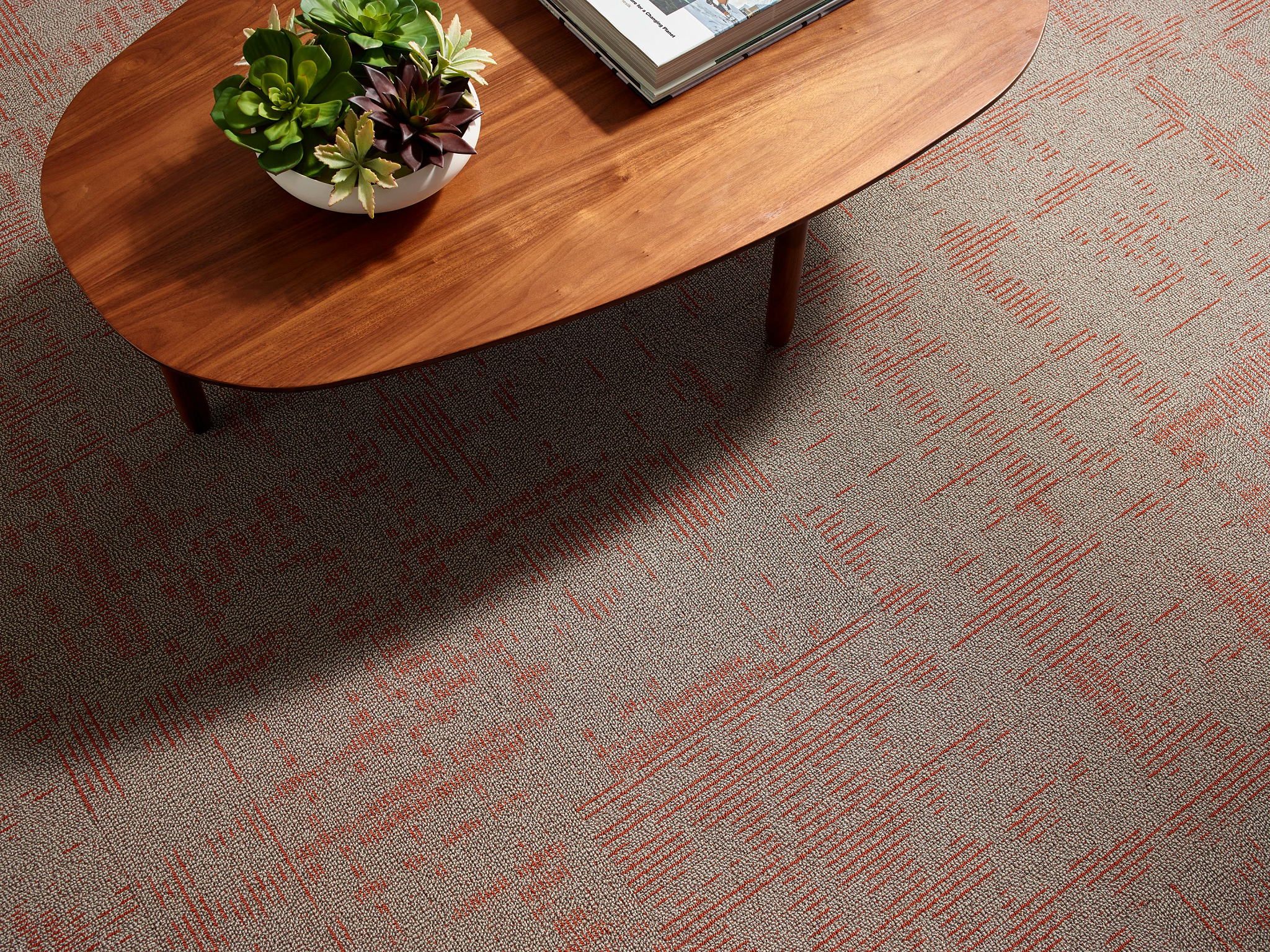 Closeup of a living room coffee table and carpet tile flooring
