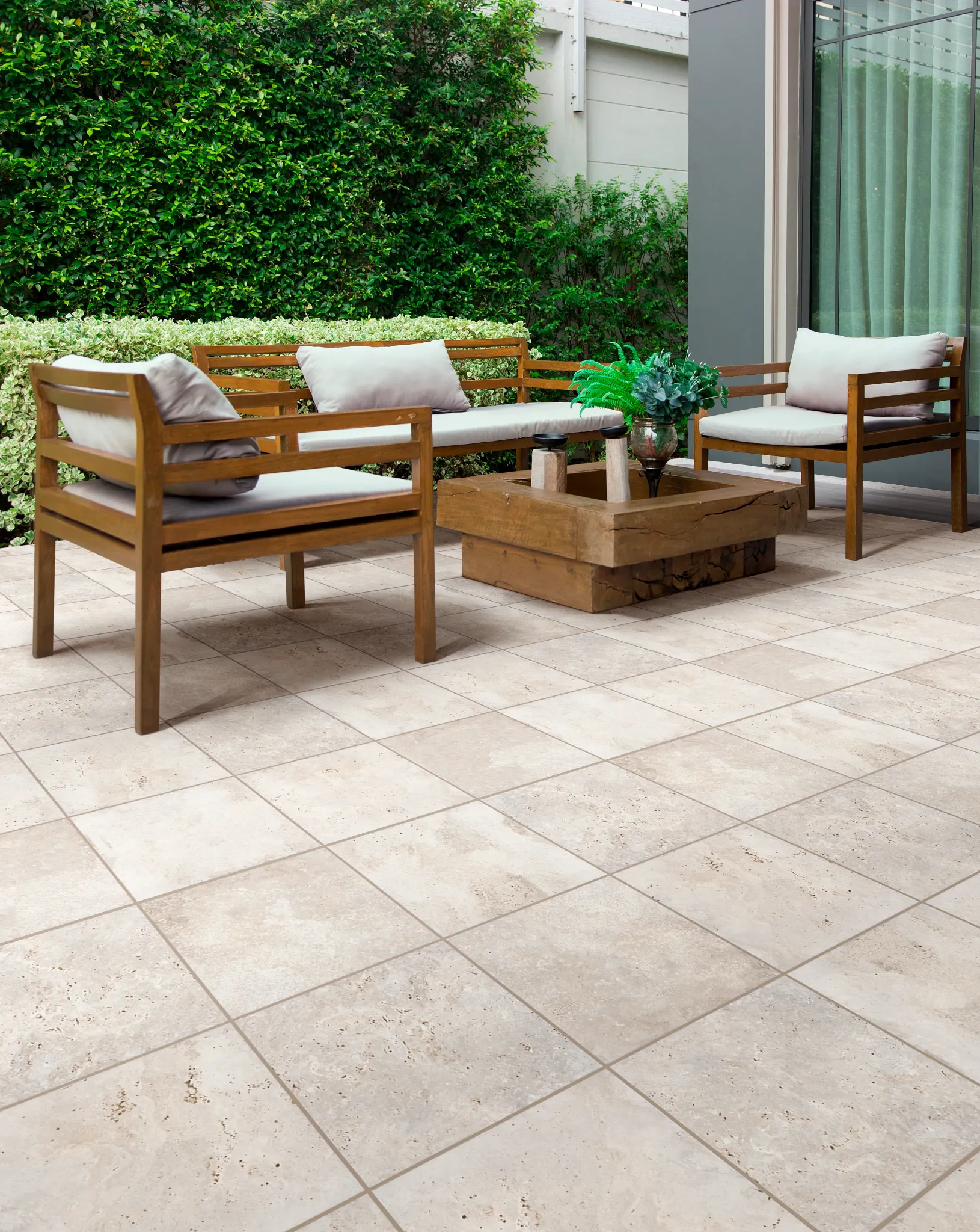 Outdoor patio with beige ceramic tile flooring and wooden furniture