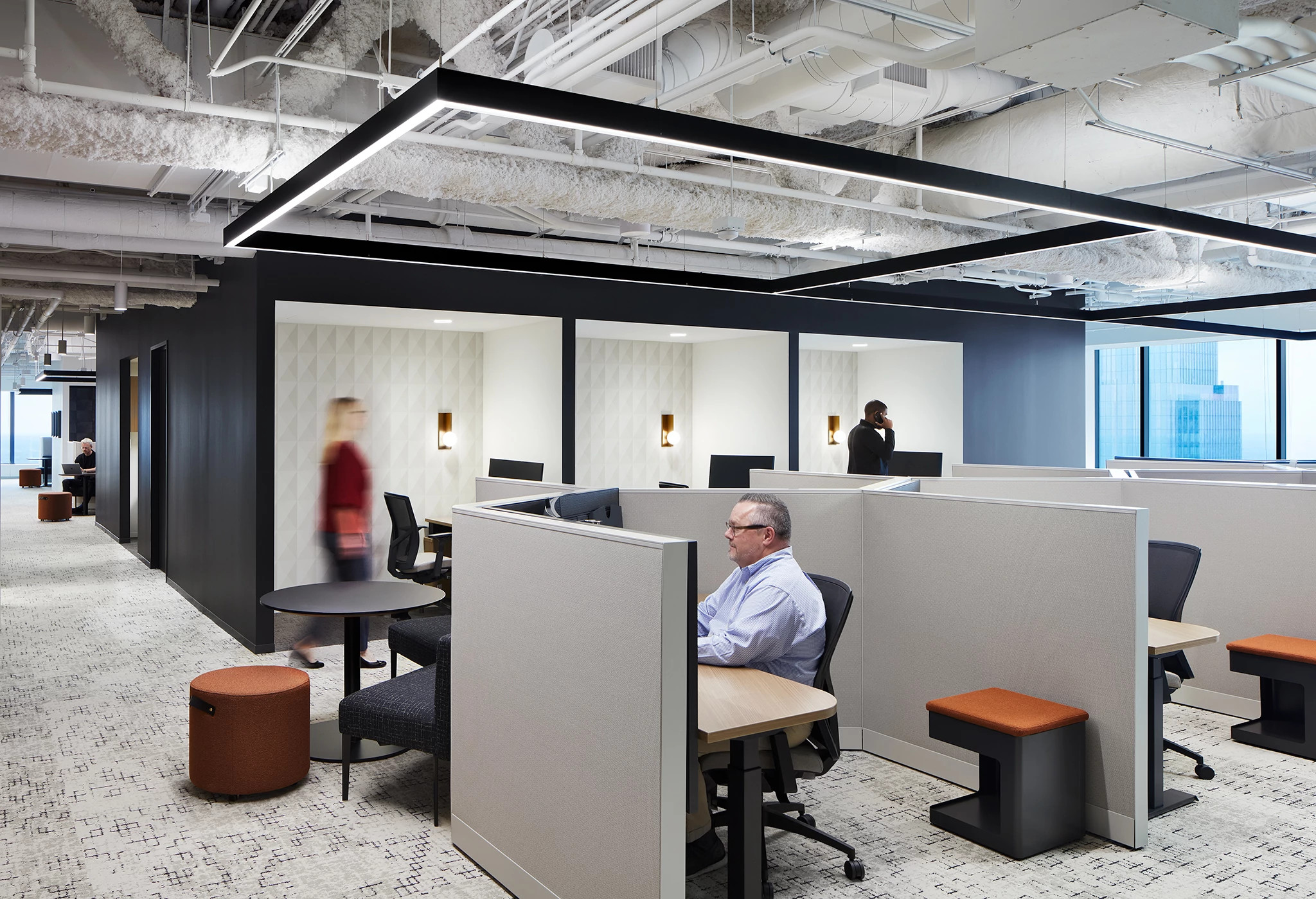 Modern office workspace with cubicles and commercial carpet flooring