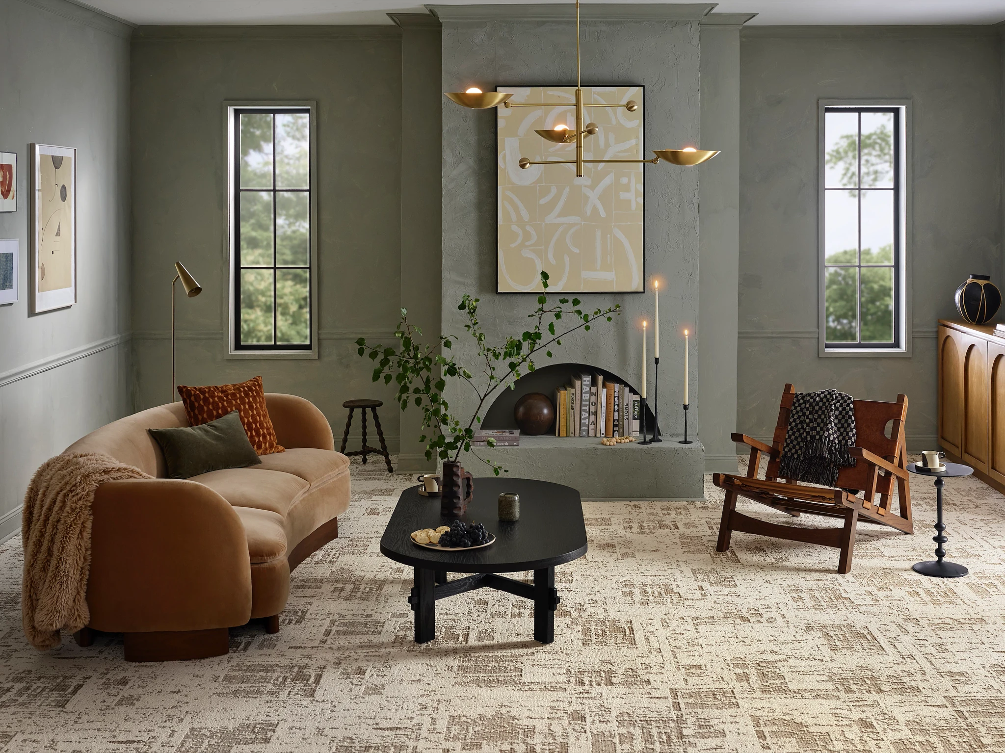 Modern living room with beige and brown carpet flooring, featuring a tan sofa, black coffee table, and wooden chair