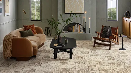 Beige and Brown Carpet Flooring in Modern Living Room Scene Modern living room with beige and brown carpet flooring, featuring a tan sofa, black coffee table, and wooden chair