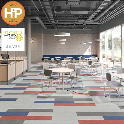 Vibrant flooring design for contemporary commercial spaces Modern cafeteria with colorful flooring in red, blue, and gray