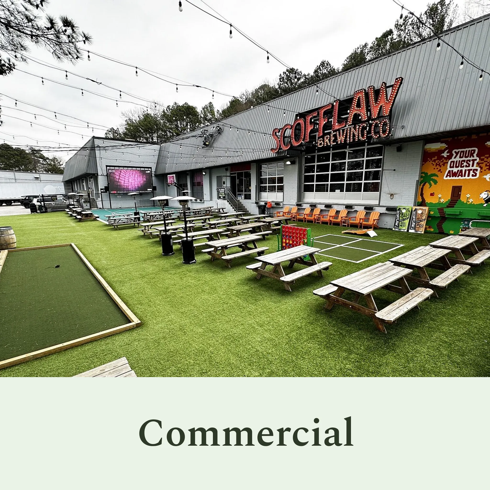 Outdoor commercial space with artificial grass and picnic tables