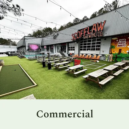 Vibrant outdoor area for commercial settings Outdoor commercial space with artificial grass and picnic tables