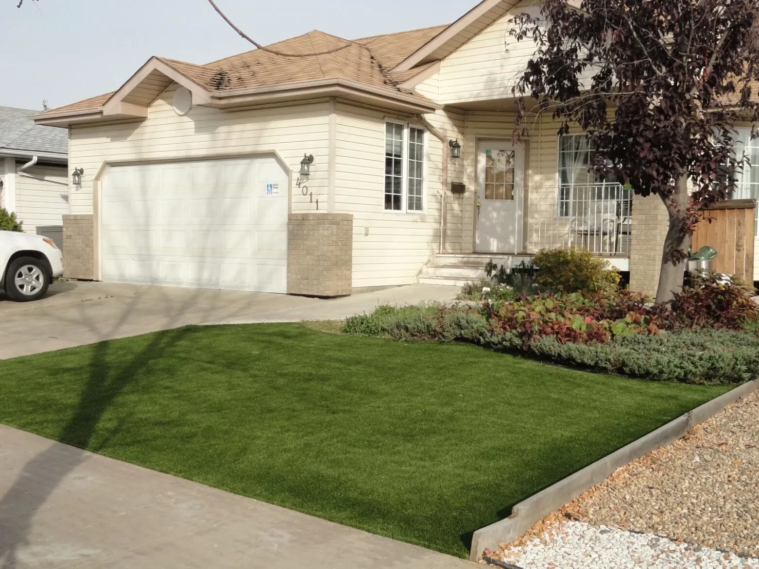 Residential home with artificial grass lawn